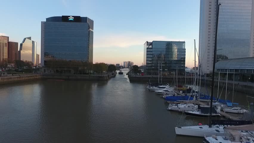 Aerial scene with drones. Camera travels forward of the ship. Puerto Madero, Buenos Aires - Argentina.