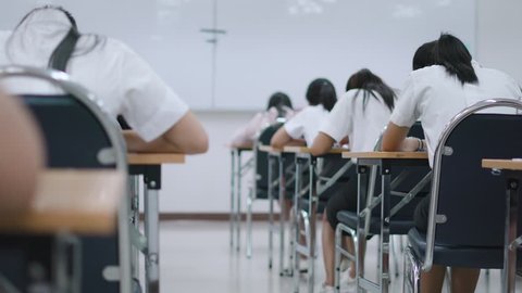 Asian students taking an exam in class room