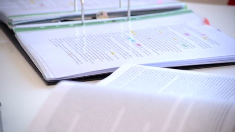 A close up panning shot of a student using a mind map to study for an exam.
