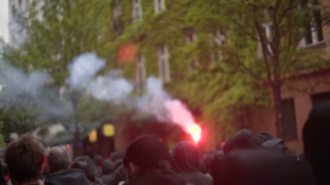 GERMANY - CIRCA MAY 2017 - Black bloc anti capitalism antifa protests, red flare, flash bang, Berlin