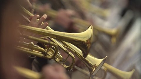 Close-up of wind instruments. Jazzman plays the trumpet. Brass tool.