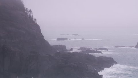 Juneau, Alaska circa-2018. Aerial view of rocky coastline in fog and rain near Juneau, Alaska. Shot from helicopter with Cineflex gimbal and RED Epic-W camera.