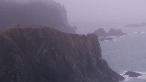 Juneau, Alaska circa-2018. Aerial view of rocky coastline in fog and rain near Juneau, Alaska. Shot from helicopter with Cineflex gimbal and RED Epic-W camera.