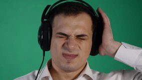 young funny man with headphones on chroma