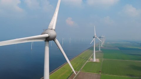 Windmill park in the lake IJsselmeer in Flevoland Netherlands , windmill farm offshore and onshore 