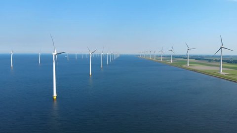 Windmill park in the lake IJsselmeer in Flevoland Netherlands , windmill farm offshore and onshore 