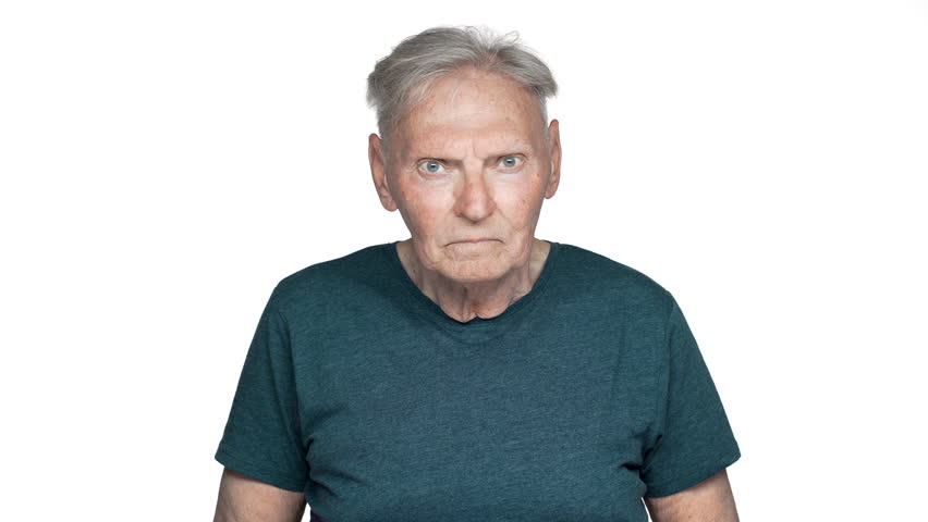 Portrait of impressed old aged man 70s having gray hair in basic t-shirt covering face in surprise, isolated over white background