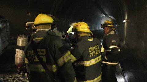 Firefighters get instructions from their commander using words and hands during a drill in Ixal Tunnels. Nazareth, Israel, May 06, 2018