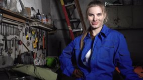 cute girl mechanic in a garage on the background of the instruments smiling. Women's equality. - Powered by Shutterstock - Get 15% off with code: PIKWIZARD15