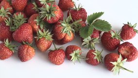 Group of fresh strawberries on white background. Dolly shot.