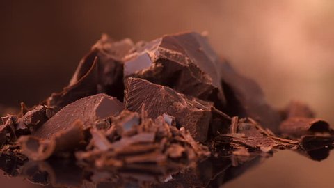 Chocolate, Chunks of sweet dark chocolate rotated, close-up. Gourmet dessert ingredient. Confectionery, confection concept. Slow motion 4K UHD video