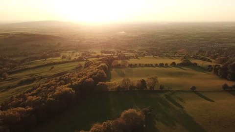 Aerial of golden sunset in Cotswold landscape scenery in England