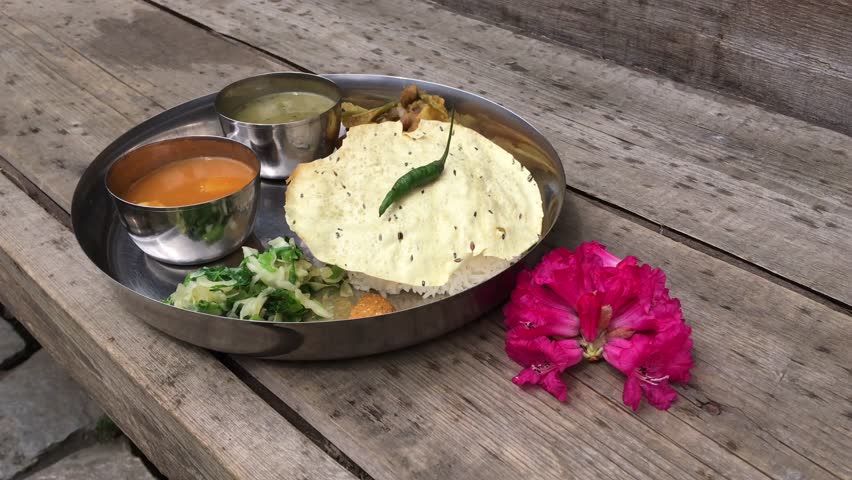 Tradition Nepal food on wooden table. Prawn Thali nepalese cuisine. Nepali khan set, free copy space.