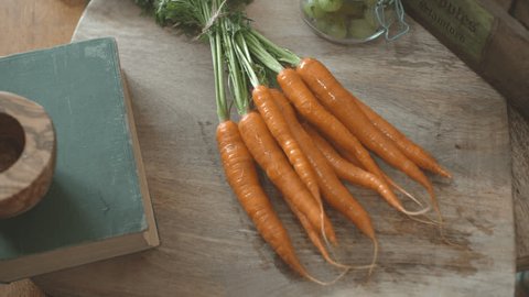 Carrots placed on farm house table Arkivvideo