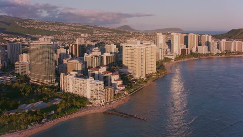 Honolulu, Oahu, Hawaii circa-2018. Aerial view of Waikiki resorts and beach in late evening sun. Shot with Cineflex and RED Epic-W Helium.