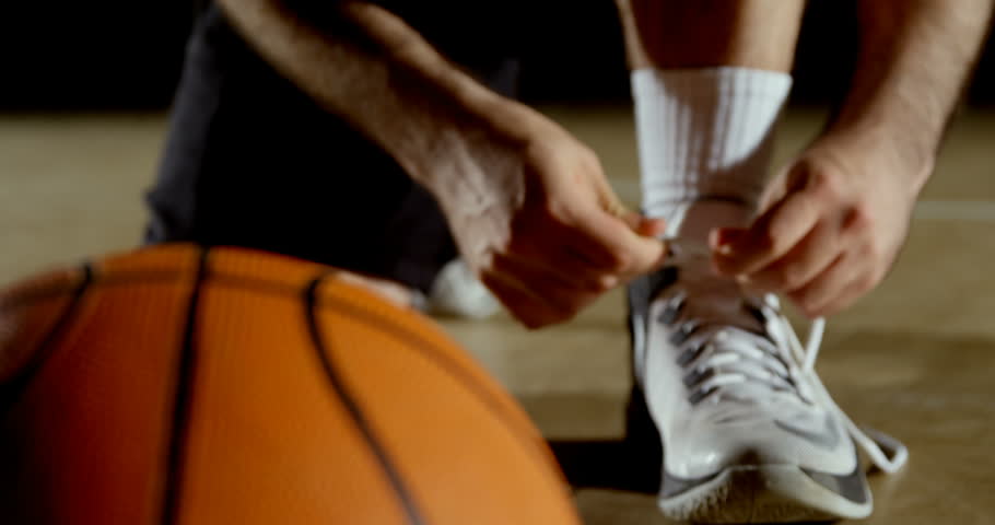 Close-up of basketball player wearing shoes in the court 4k