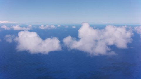 Oahu, Hawaii circa-2018. Aerial view of clouds over Pacific Ocean between Oahu and Kauai. Shot with Cineflex and RED Epic-W Helium.