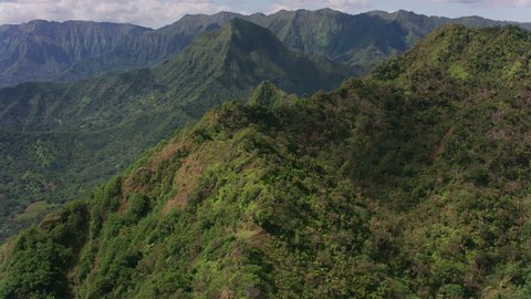 Oahu, Hawaii circa-2018. Aerial view of rugged cliffs and forest. Shot with Cineflex and RED Epic-W Helium.