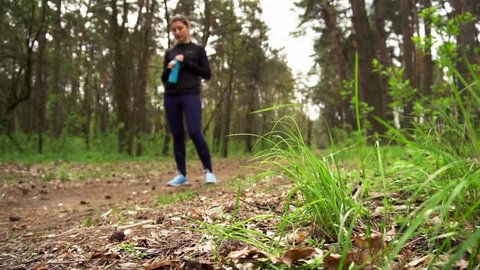 Runner athlete running on forest trail. woman fitness jogging workout concept.