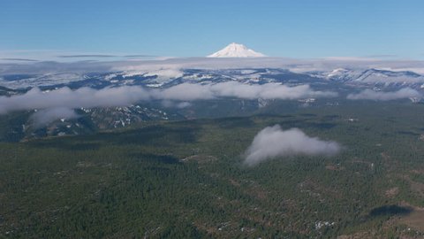 Oregon circa-2018. Flying towards Mt. Jefferson with low clouds. Shot from helicopter with Cineflex gimbal and RED Epic-W camera.