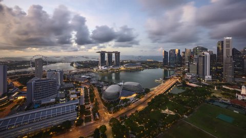 4k UHD time lapse of day to night to day, from sunset to sunrise at Singapore Marina Bay city skyline. Zoom out