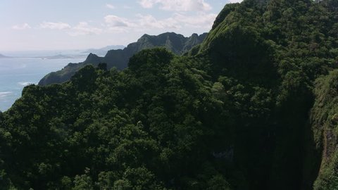 Oahu, Hawaii circa-2018. Aerial view of rugged cliffs and forest. Shot with Cineflex and RED Epic-W Helium.