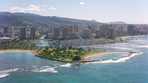 Honolulu, Oahu, Hawaii circa-2018. Flying over Magic Island and Waikiki. Shot with Cineflex and RED Epic-W Helium.