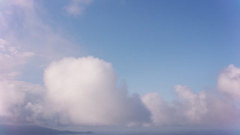 Maui, Hawaii circa-2018. Aerial timelapse shot of clouds over ocean approaching Maui. Shot with Cineflex and RED Epic-W Helium.