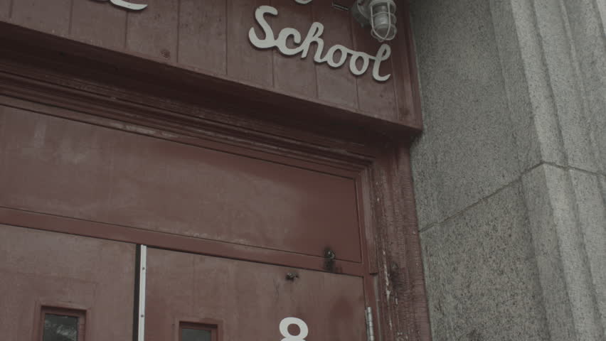 Front doors of school with old school lettering