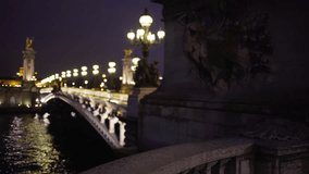 Romantic night scene of Alexandre III bridge across the Seine River in Paris. Blurred light posts and sculptures on famous French bridge at night in Paris France