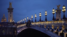 Lovely view of Alexandre III bridge across the Seine River at night. Twilight view of famous French landmark in Paris