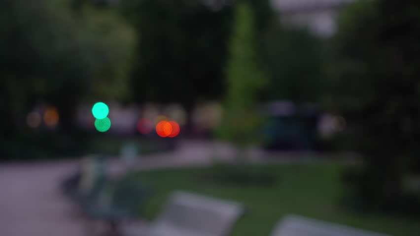 Bokeh night scene of urban park in Paris. Out of focus city park in a twilight setting in Europe