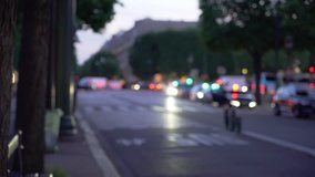 Blurry background plate of street traffic in urban setting Paris France. Out of focus view of cars traffic lights and people walking on a busy road