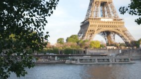Daylight view of the Eiffel Tower across the River Seine in Paris France. Defocused view of the famous French landmark next to river