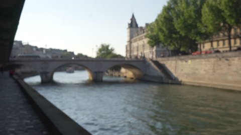 Sidewalk view of French bridge over the Seine River in Paris. Small water bridge in urban setting
