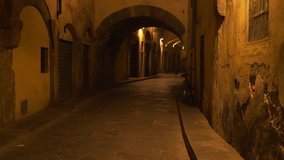 Low lighting archway street alley in Europe. Blurred background plate of arches on an empty street