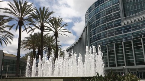A slow pan down from the top of the Anaheim Convention Center to the beautiful fountain