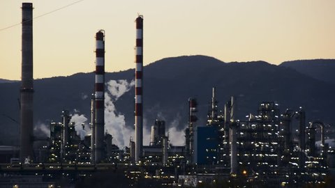 Factory Smoke stack. Petrochemical plant, Oil and gas refinery at twilight