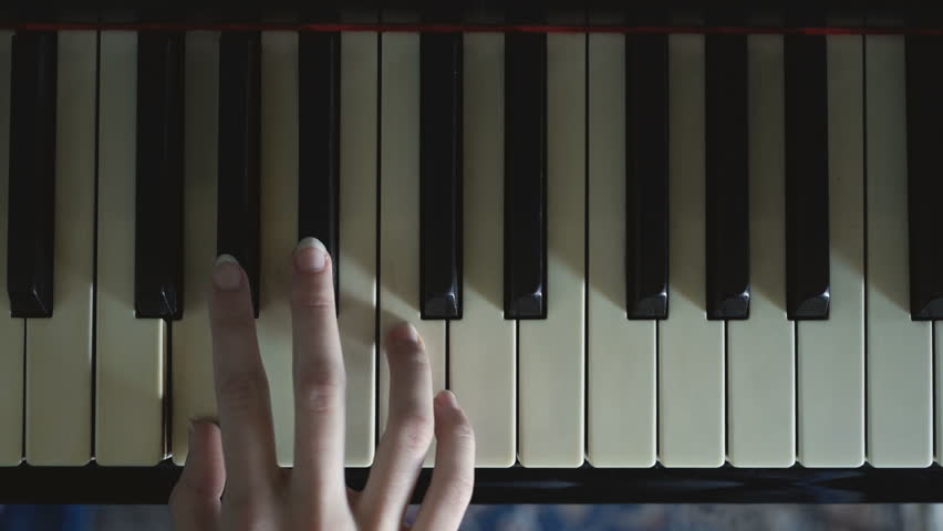 A girl playing a scale slowly on the piano. Royalty-Free Stock Footage #1011802097