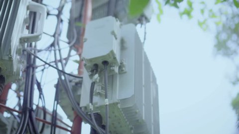 Transmitter at Telecommunication GSM (5G,4G) tower.The cellular phone antennas in city areas.Telecom network base station.Technology for communication.Footage 4k
