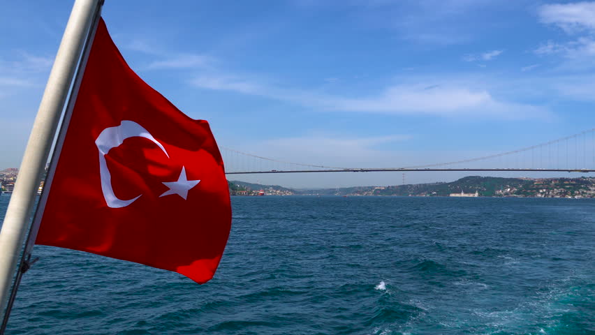 Turkish flag waving on the stern of an Istanbul Ship is Floating