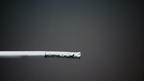 Burning cigarette with smoke on isolated background
