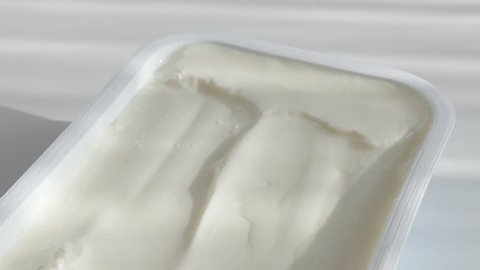 Cream cheese in plastic box 4K tilting footage