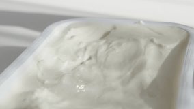 Taking cream cheese with shiny spoon 4K video