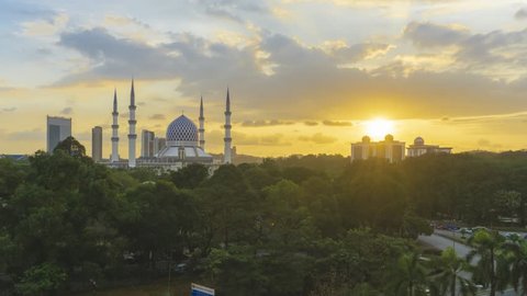 High Angle Dramatic Sunset Time Lapse at Sultan Salahuddin Abdul Aziz Mosque. Shah Alam, Malaysia. Day to Night. Pan down motion timelapse.