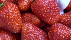 Ripe red strawberry mixed with yogurt slow motion video