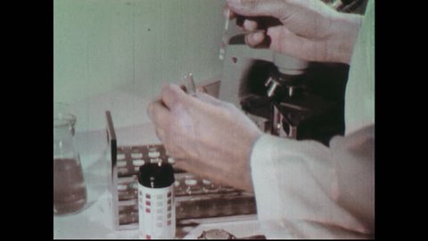 1970s: Hands check litmus paper. Doctor consults abdominal x-rays. Scientist at table with petri dishes. Hand holds up petri dish culture.
