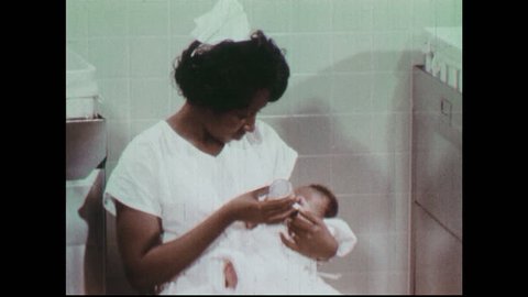1970s: Nurse feeds baby in hospital room. Doctors examine newborn in hospital crib. Doctor and nurse examine abdomen of baby.
