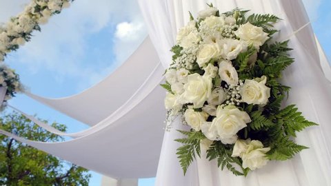 Beautiful static video 4k of the Jewish Hupa , wedding putdoor .Beautifully registered Huppa with a set of flowers.Closeup on a bouquet from roses.
