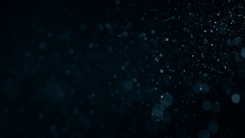 Natural Organic Dust Particles Floating On Black Background. Dynamic Dust Particles Randomly Float In Space With Slow Motion. Shimmering Glittering Particles With Bokeh. Real Colored Particles In Air. Royalty-Free Stock Footage #1011848321